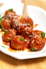Meatballs in tomato sauce with parsley and parmesan