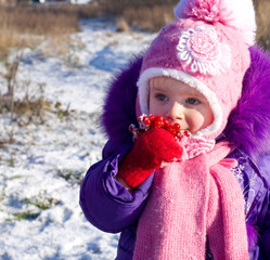 Portrait of happy little girl in snowy landscape