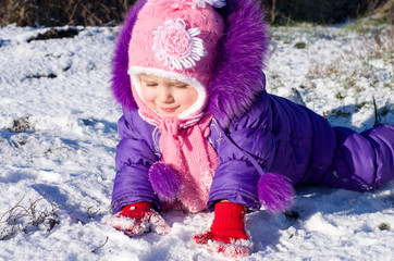 Portrait of happy little girl in snowy landscape