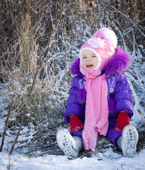 Portrait of happy little girl in snowy landscape