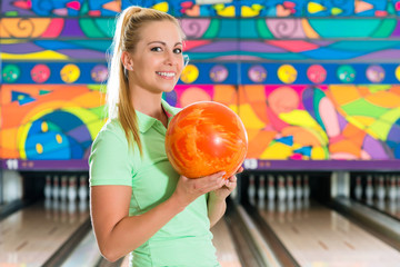 Fototapeta premium Young woman bowling having fun
