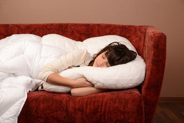 happy young girl slipping on sofa