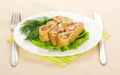 Pancakes with salmon on yellow