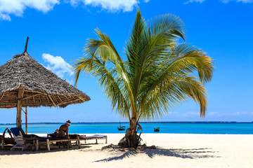 Woman sitting at a tropical beach