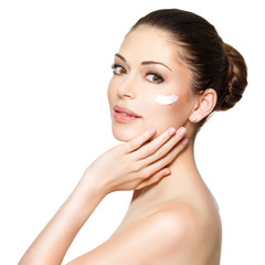 Beauty face of woman with cosmetic cream on face