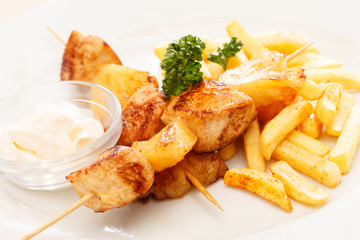 Chicken skewers with french fries