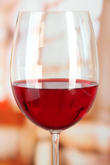 Glass of wine on room  background close-up