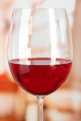 Fotobehang Glass of wine on room  background close-up © Africa Studio