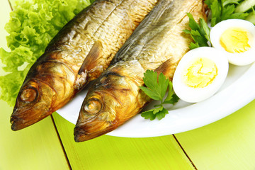 Smoked fish on plate close up