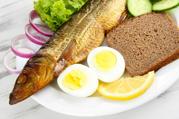 Smoked fish on plate close up