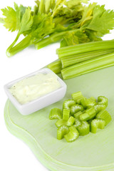 Fresh green celery on cutting board close-up