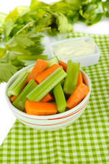 Fresh green celery with vegetables in bowl on table close-up