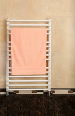 Color towel on  radiator in bathroom