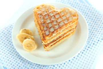 Sweet Belgium waffles with banana, isolated on white