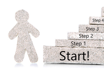 Little man and building blocks in shape of stairs isolated
