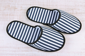Striped slippers on wooden background