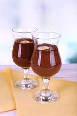 Cocktails with banana and chocolate on table on light