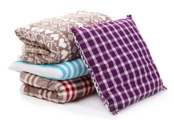 Warm plaids and pillows isolated on white