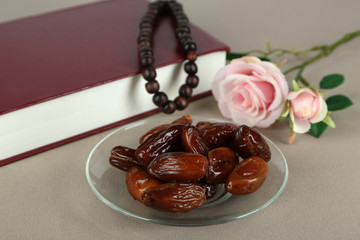Composition with holy book,rosary and dates palm,
