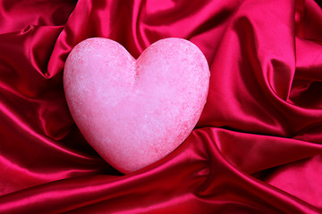 Decorative red heart, on color fabric background