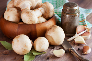 Raw mushrooms, garlic, bay leaf and pepper. Prepared for cooking