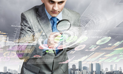 Man looking in magnifier