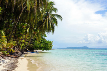 Naklejka na ściany i meble Tropical beach island with a boat