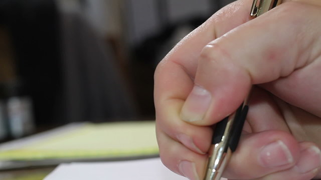 Man writing with fancy pen shallow depth of field