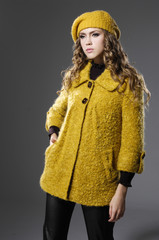 fashionable girl in yellow clothing posing