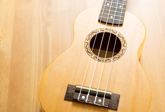 ukulele on wood background
