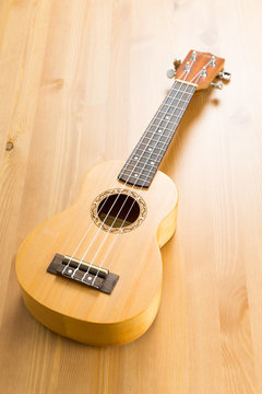 ukulele on wood background