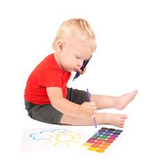 year-old child during painting a sun by brush and watercolours