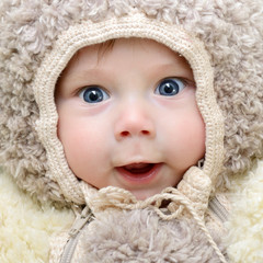 Fototapeta na wymiar cute funny infant boy like a bear, beautiful kid's portrait