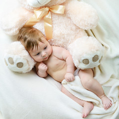 cute funny infant baby boy with big toy bear, beautiful kid's po