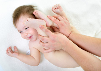 massage of cute smiling baby girl