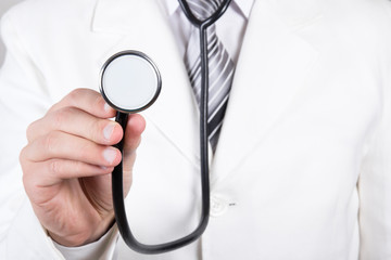 Close up of a doctors hand with stethoscope