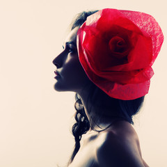 Vintage portrait of fashion glamour girl with red flower in her