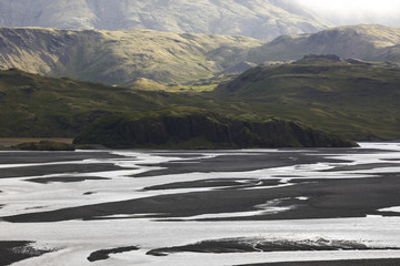 Iceland. East fjords. Lonsvik. Water and sand from glaciers.