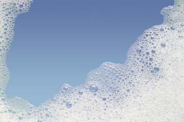 Border of bubble foam soap in blue water. - obrazy, fototapety, plakaty