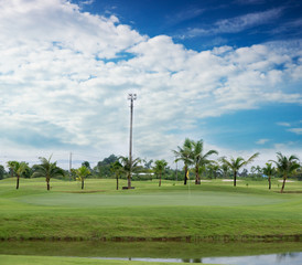 Landscape of a beautiful green golf field with bright blue sky