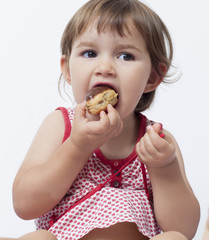 young child loving to eat sweet cakes