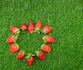 Heart shaped Strawberry frame on green grass