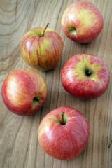 colored apples on wooden background