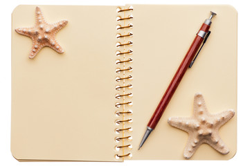 Notebook, pen, starfishes