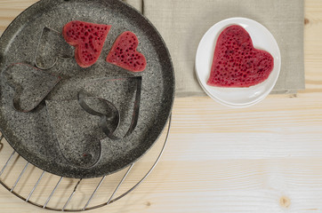 Valentine's Day red pancakes in heart shape with sour cream