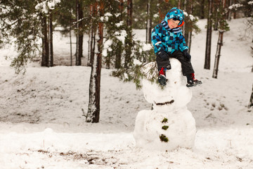 Little boy and snowman