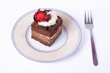 Chocolate cake with fork and strawberry