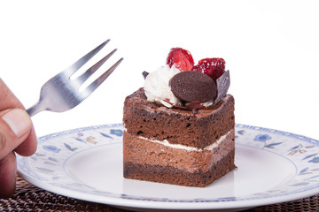 Chocolate cake with fork and strawberry