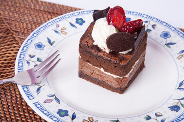 Chocolate cake with fork and strawberry