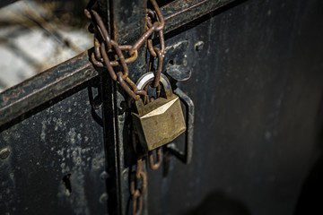 rusty chain on a metal door with  padlock